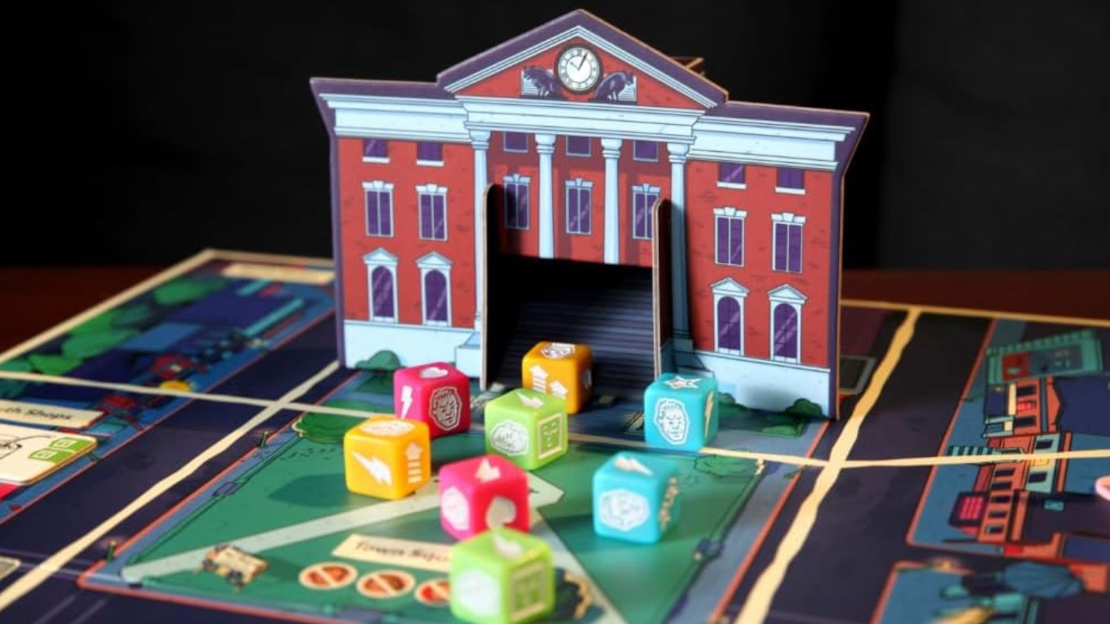 The Back to the Future: Back in Time townhall and clocktower on a board, with dice in front of it