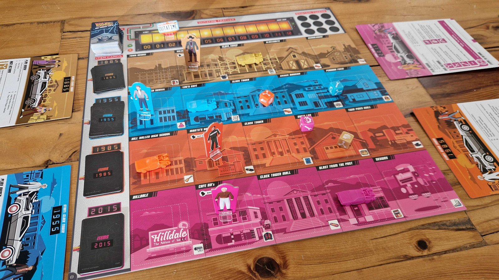Back to the Future: Dice Through Time board, cards, tokens, and dice on a wooden surface