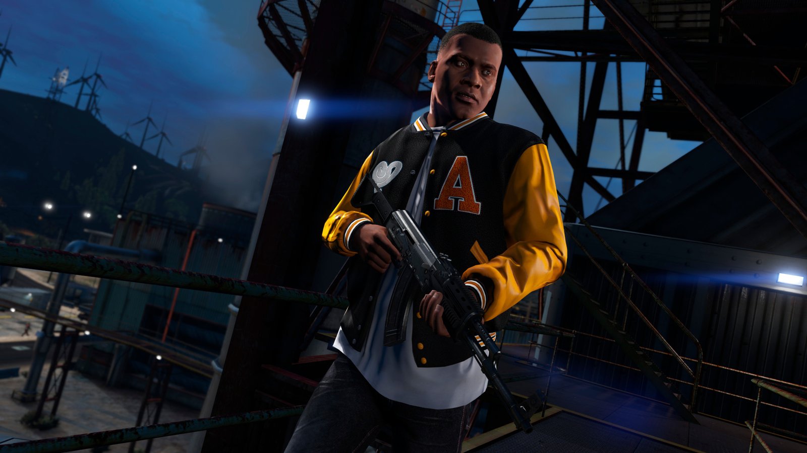 A GTA 5 screenshot showing protagonist Franklin standing on a platform above a warehouse complex and wears a Varsity-style jacket while holding a rifle