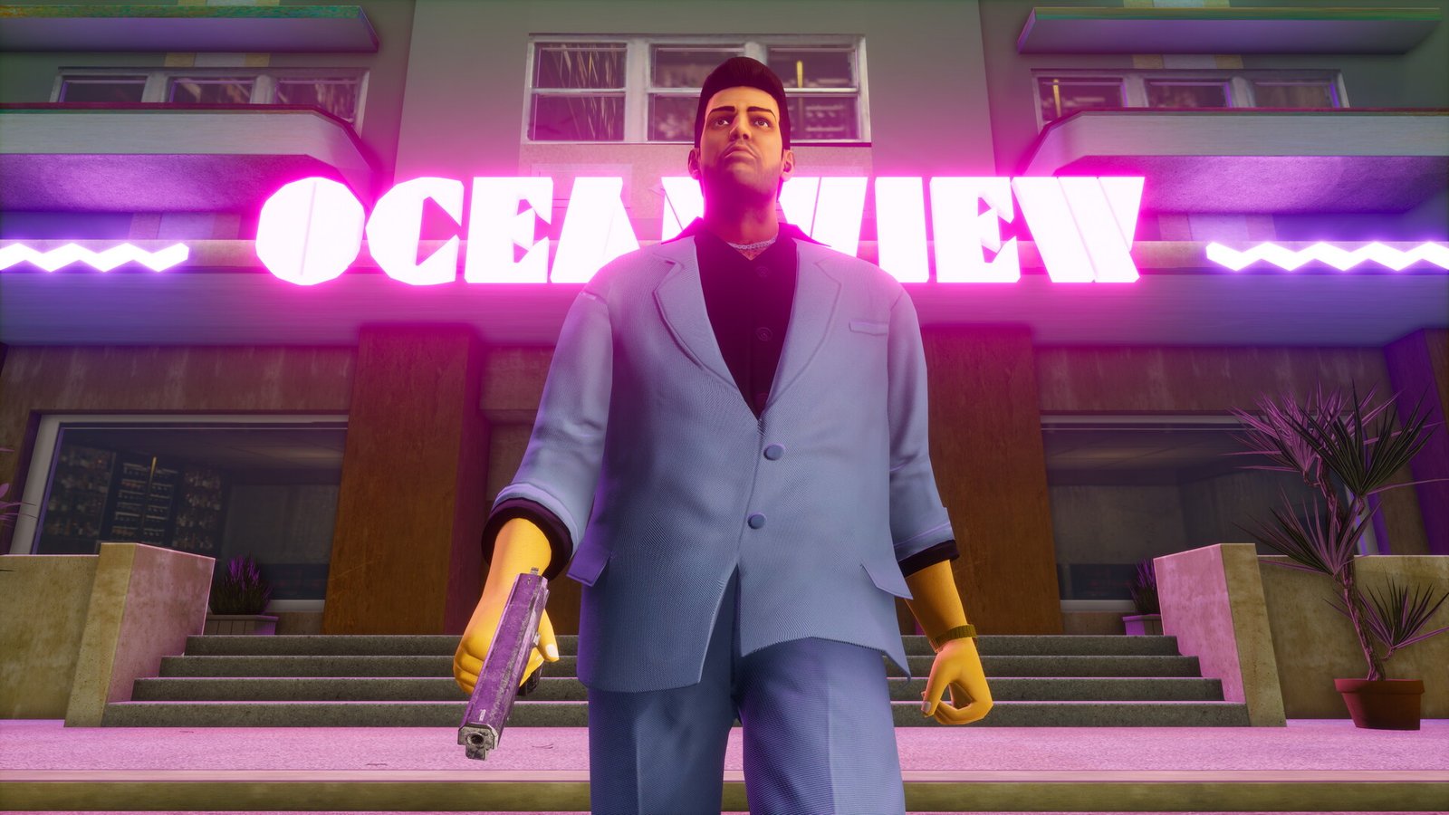 GTA: Vice City protagonist Tommy Vercetti walks out of the Oceanview club while wearing a grey suit and wielding a pistol in his rand hand