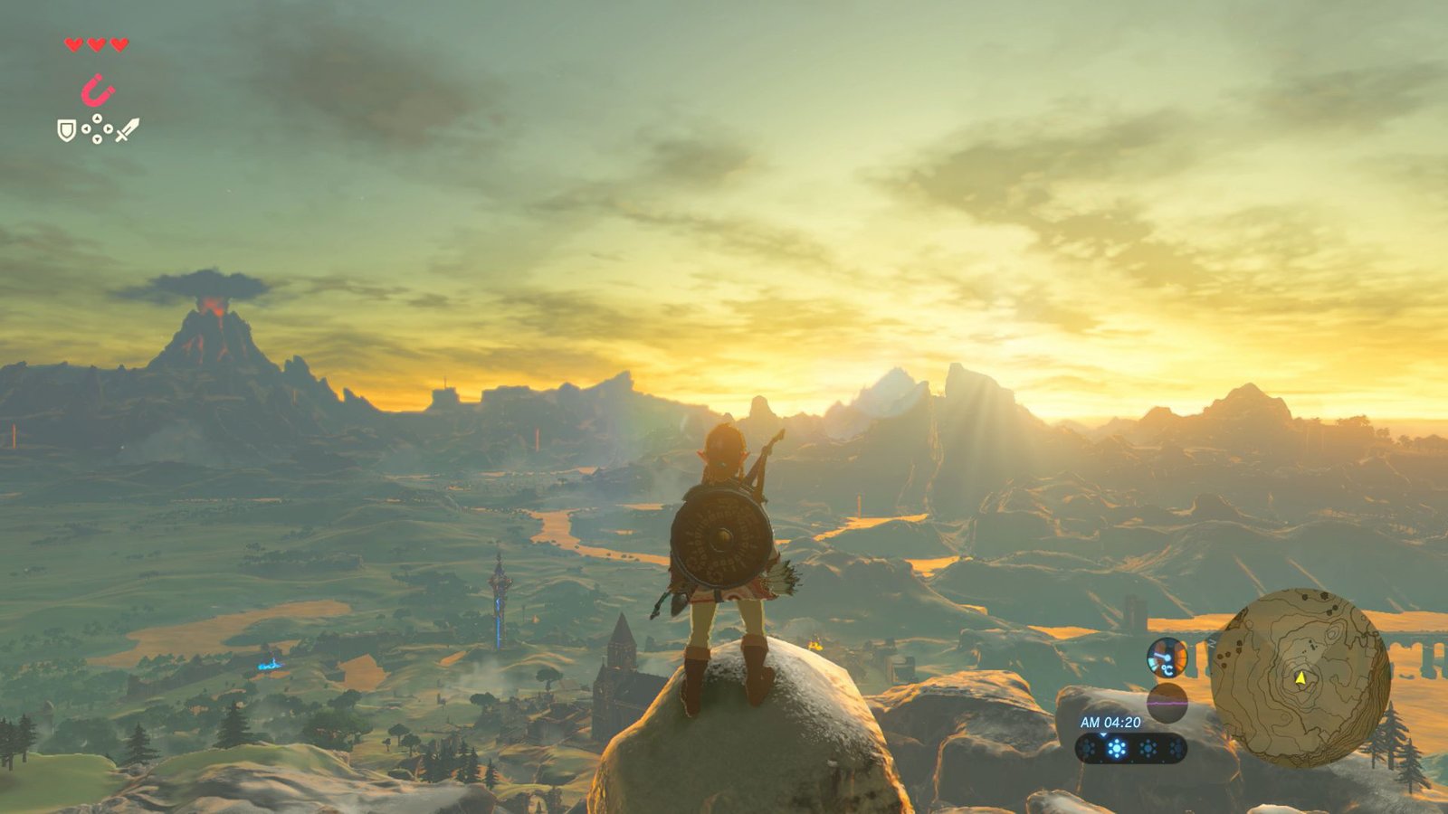 Best Zelda games: The Legend of Breath of the Wild screenshot shows Link standing on a high peak overlooking Hyrule