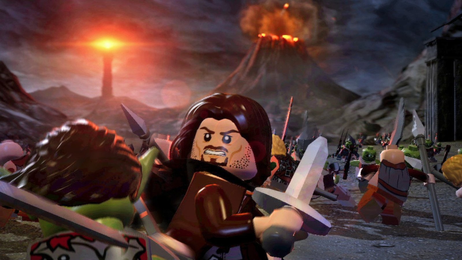 A Lego Aragorn fighting an orc in front of Mount Doom during the Lego Lord of the Rings game, showing action gameplay, and our pick for the best Middle-earth based Lego game of all time.
