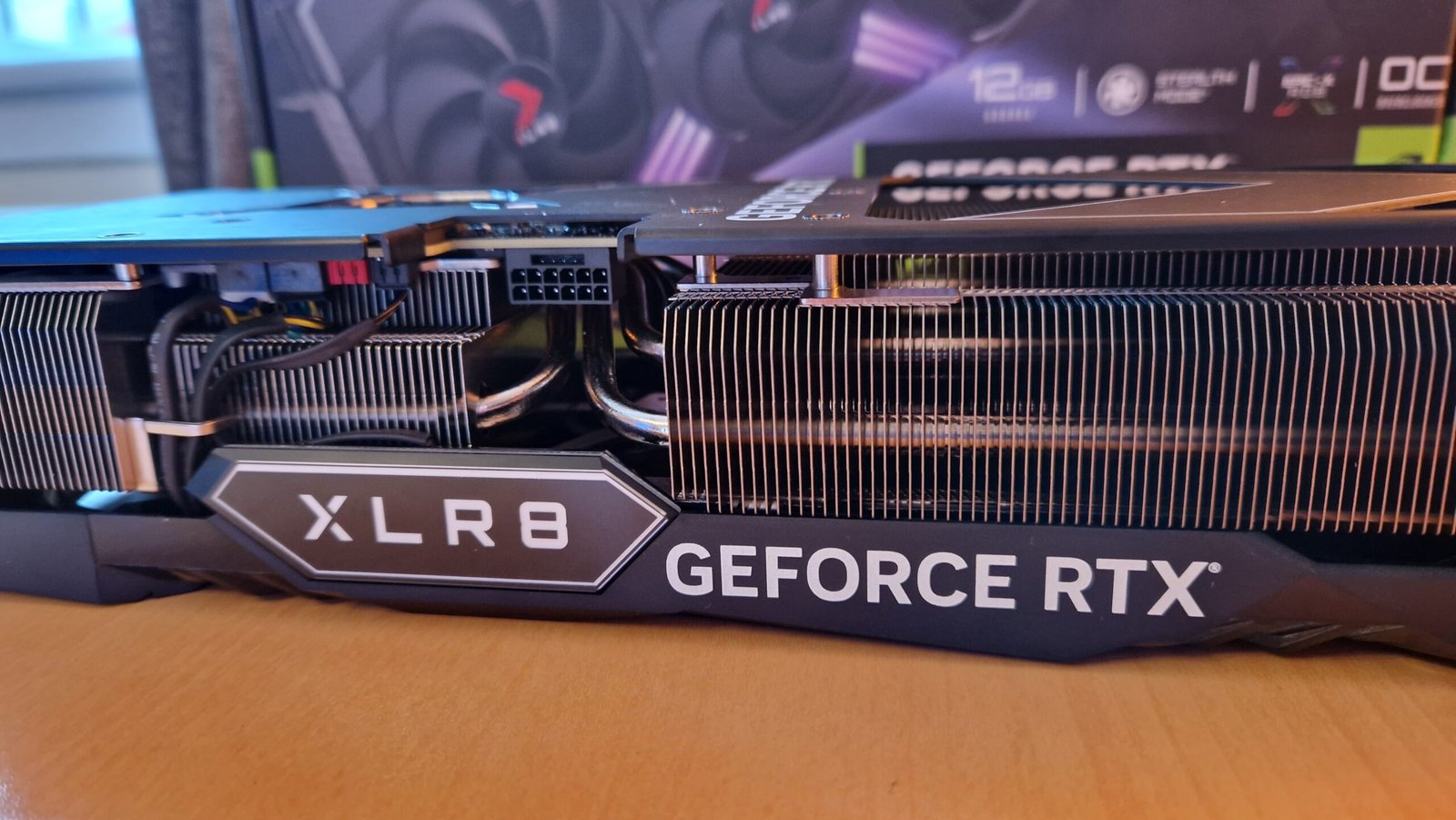 PNY GeForce RTX 4070 Ti lying on a table from the side, showing the 40 series plug socket