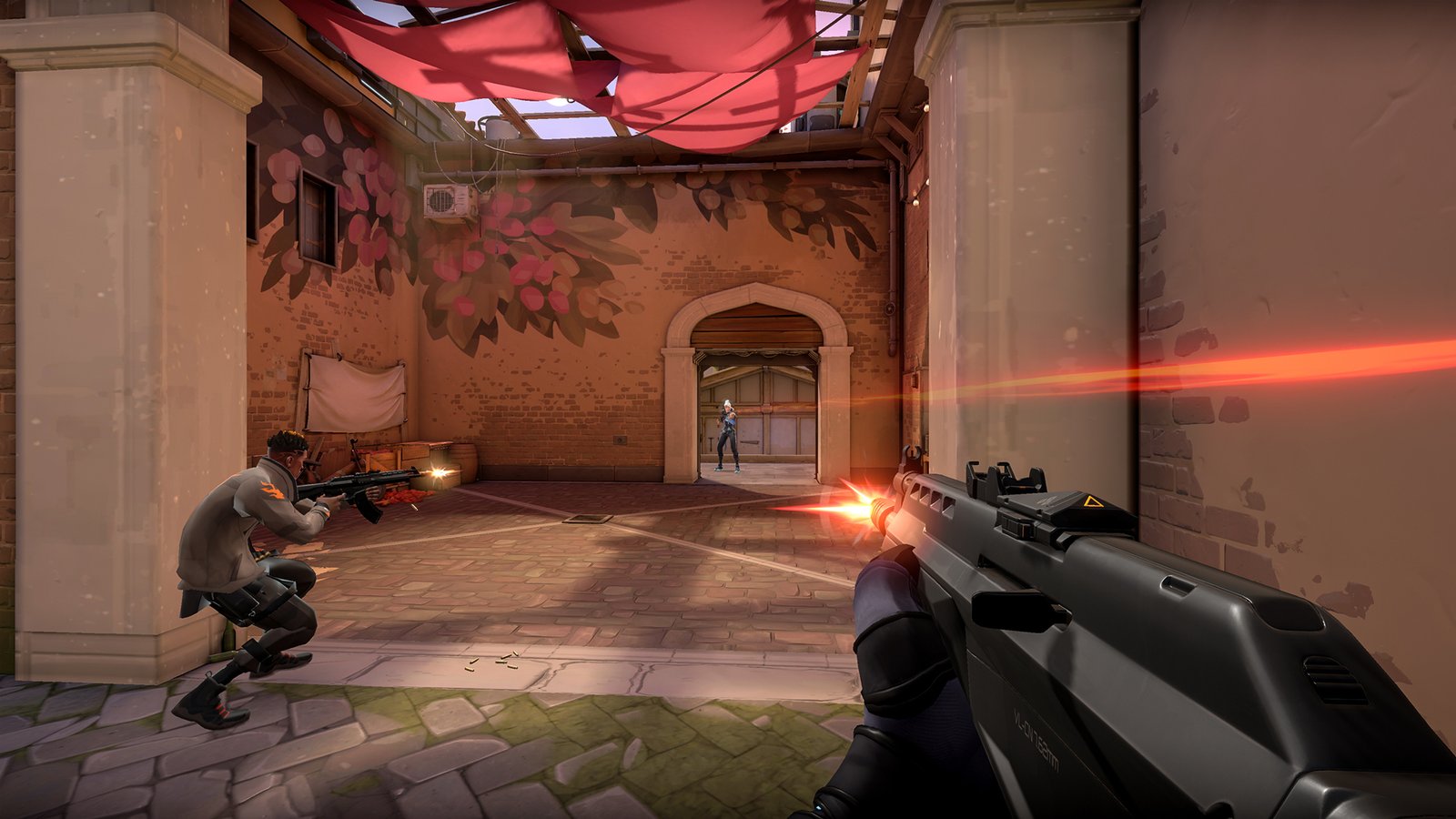 A group of players taking cover and shooting each other on a map in the FPS game Valorant.