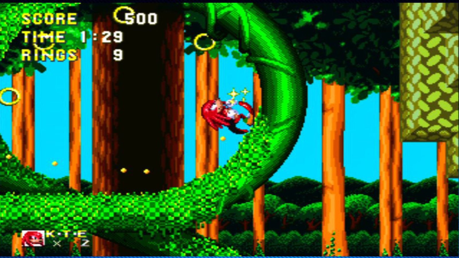 Sonic and Knuckles on the Sega Genesis shows Knuckles running along a looping vine towards some gold rings