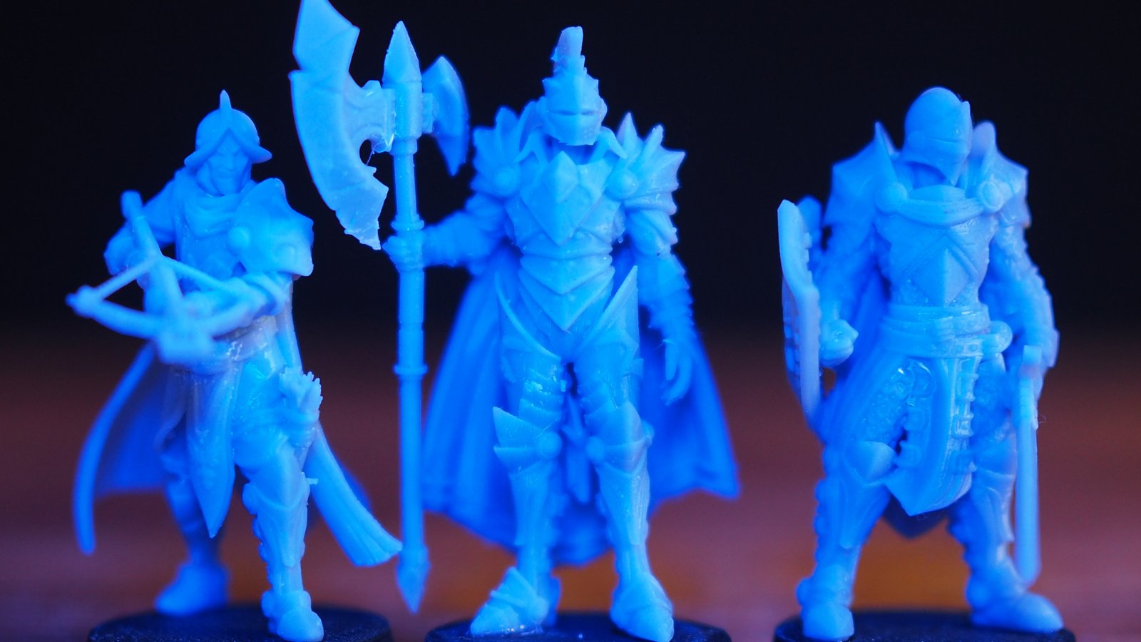 Three knights standing together on a wooden table