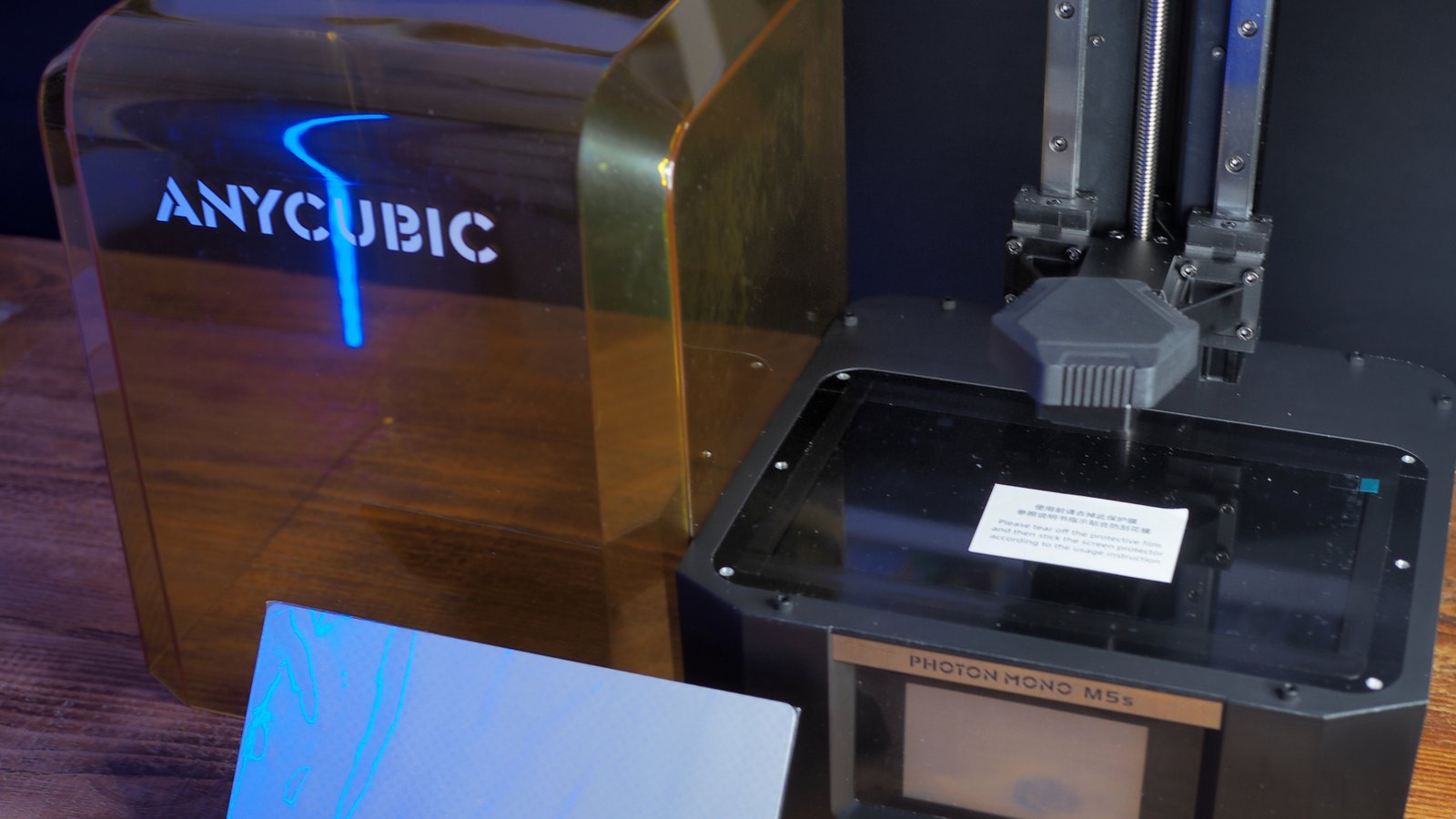 The Anycubic Photon Mono M5s in parts on a wooden table