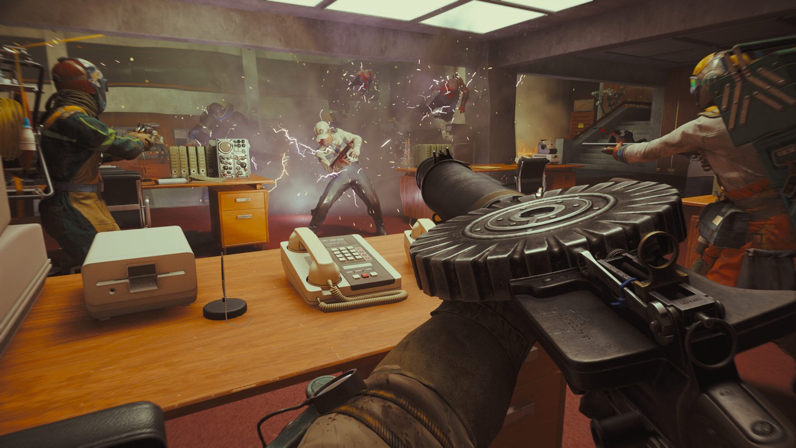 Hiss are electrocuted as they approach the squad hiding behind office desks in FBC: Firebreak