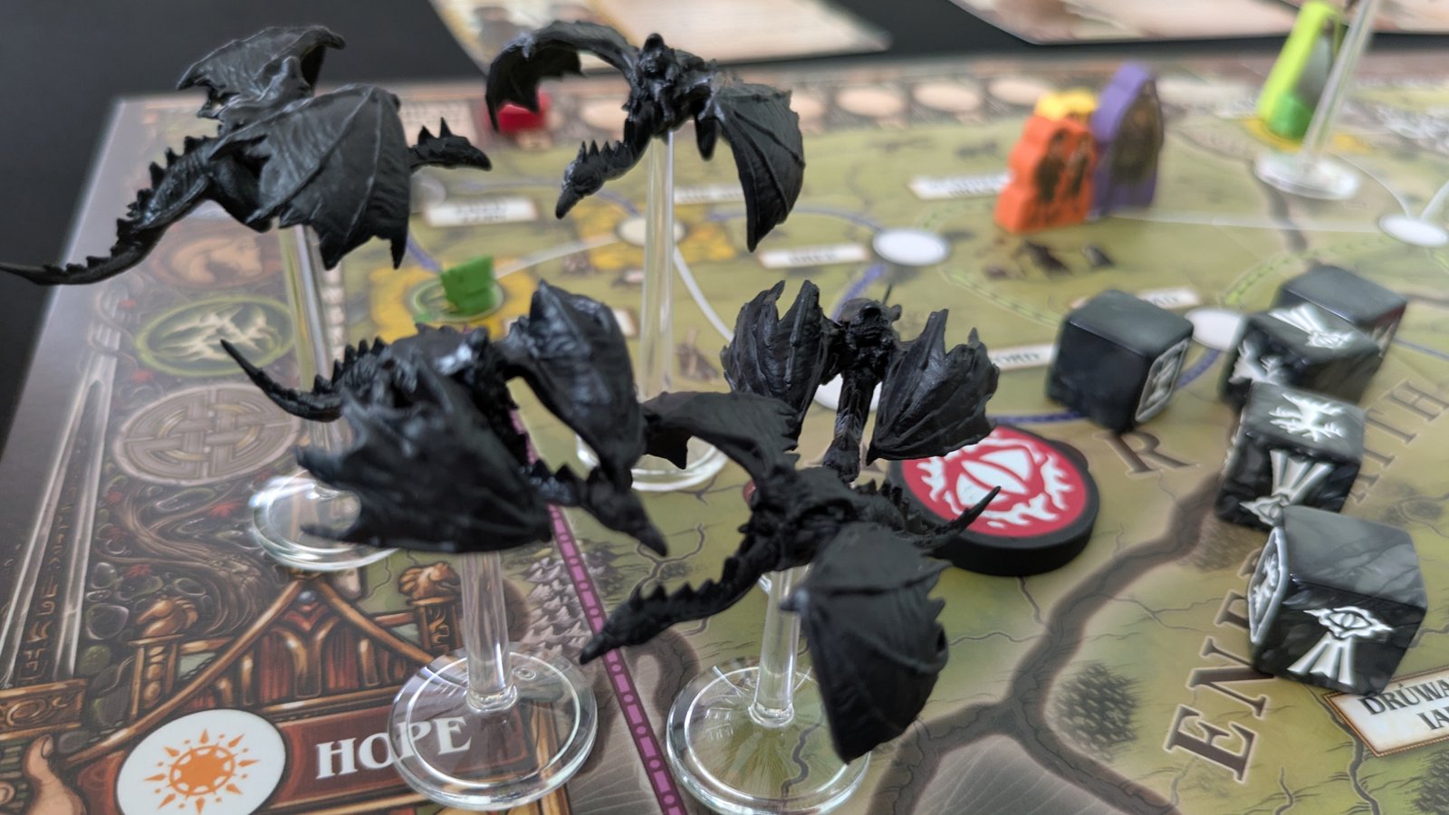 Numerous Ringwraith models alongside tokens and dice on the Fate of the Fellowship board
