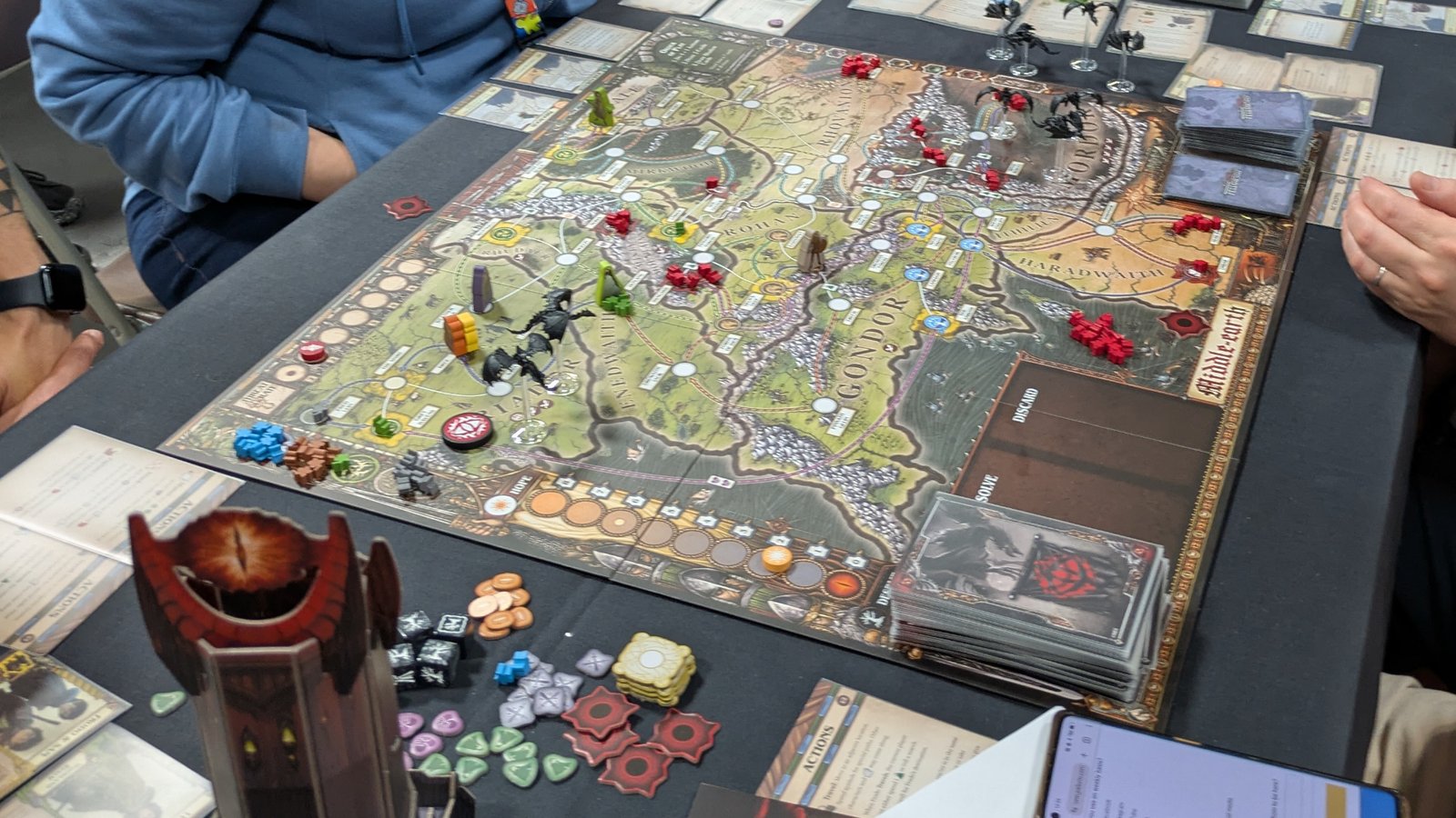 A full setup for Fate of the Fellowship with cards, tokens, and pieces all laid out
