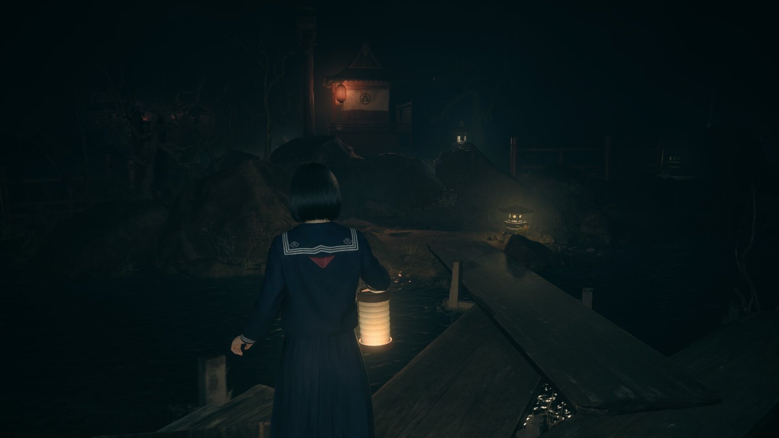 Hinako walks across wooden planks that connect jutting out bits of land in front of the dark shrine entrance in Silent Hill f