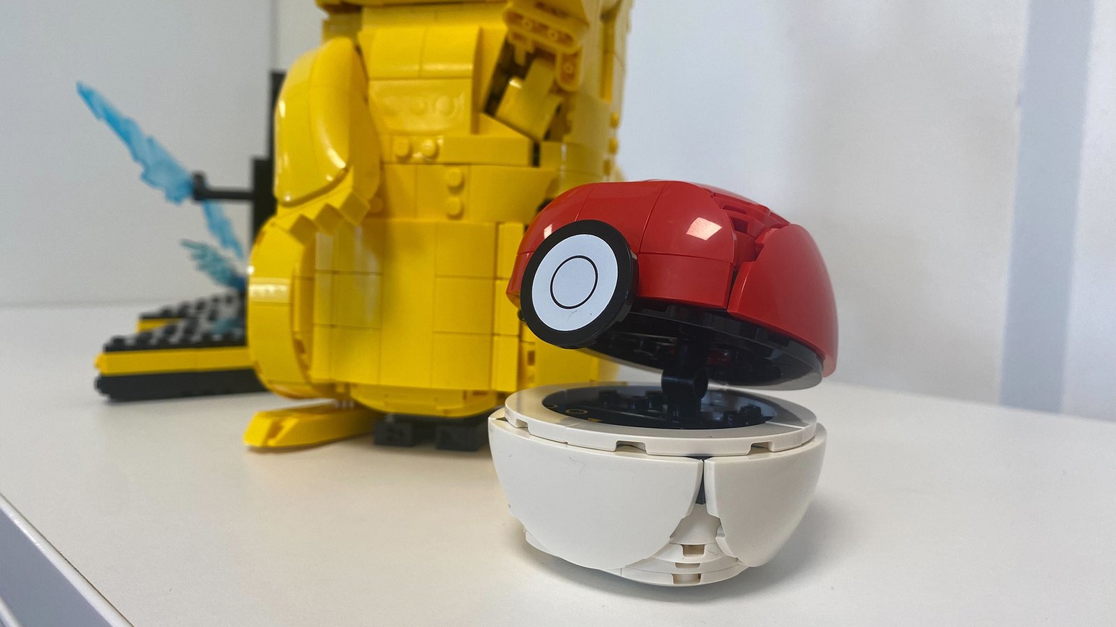 Lego Pikachu and Poke Ball set against a white background