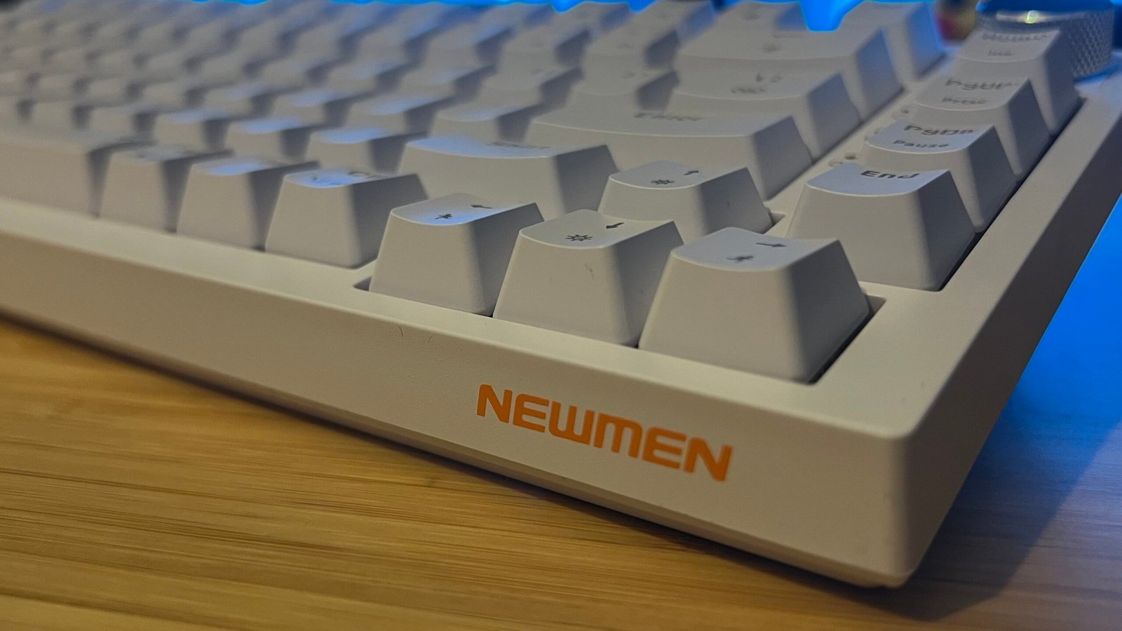 Front corner of Newmen GM326 gaming keyboard showing sides of keycaps
