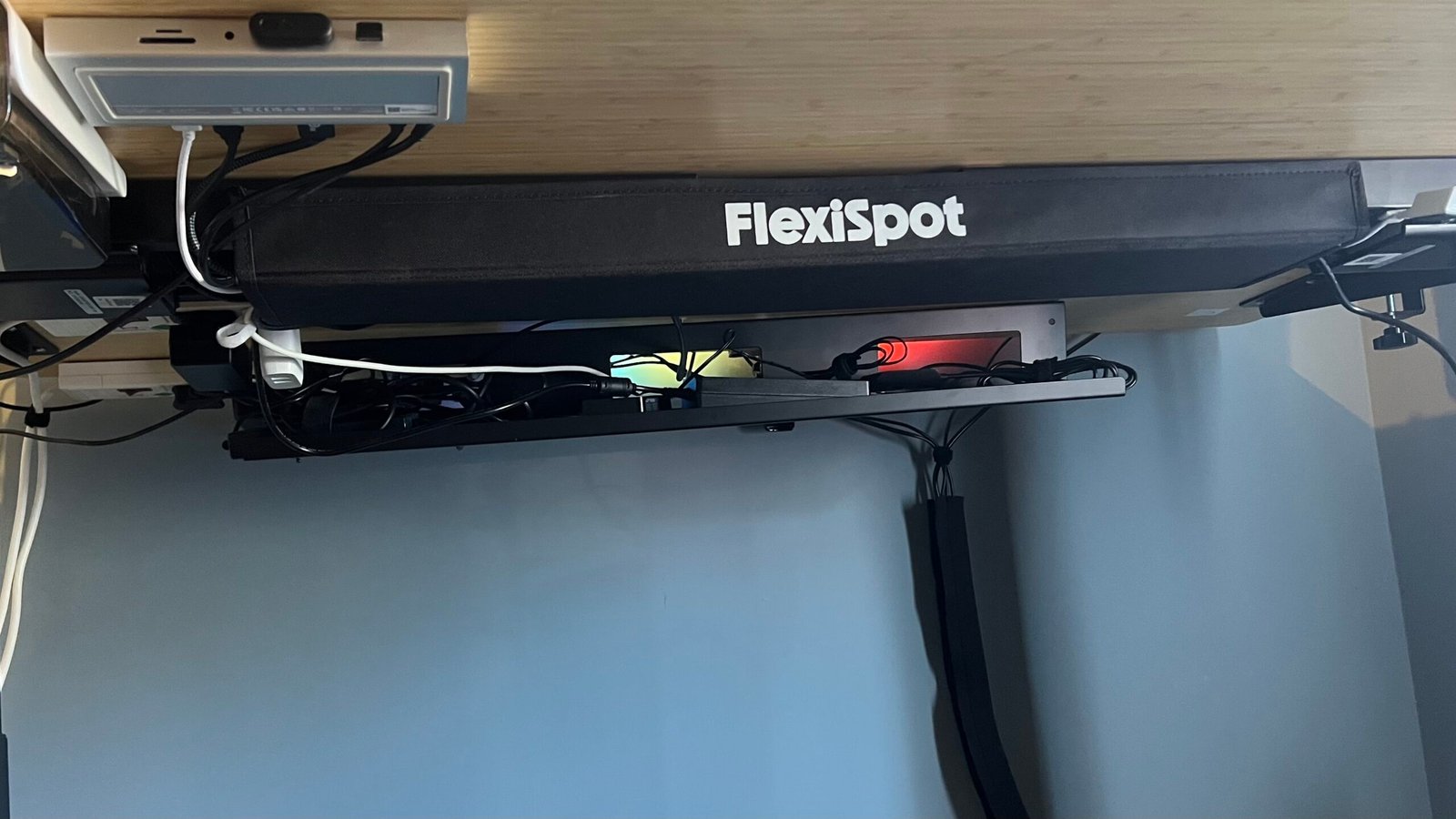 Underside of FlexiSpot desk with cable management solutions installed