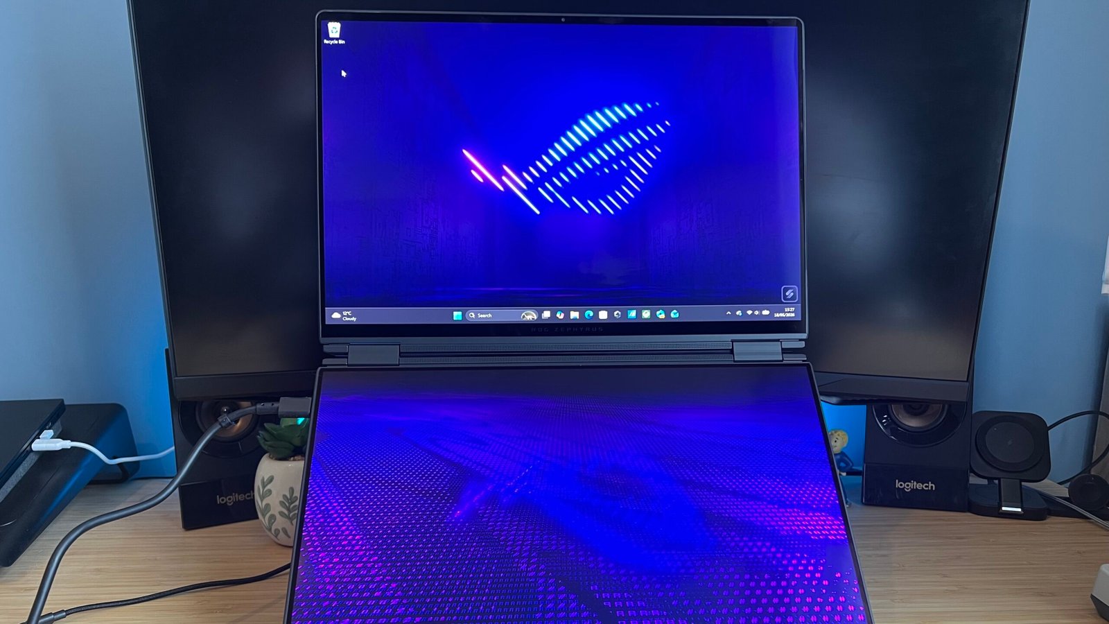 Asus ROG Zephyrus Duo in dual-screen mode on a wooden desk