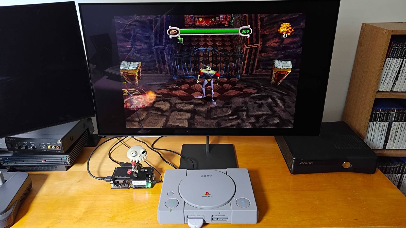 Original PlayStation console connected to Dough Spectrum Black monitor via OSSC upscaler with MediEvil gameplay on screen.