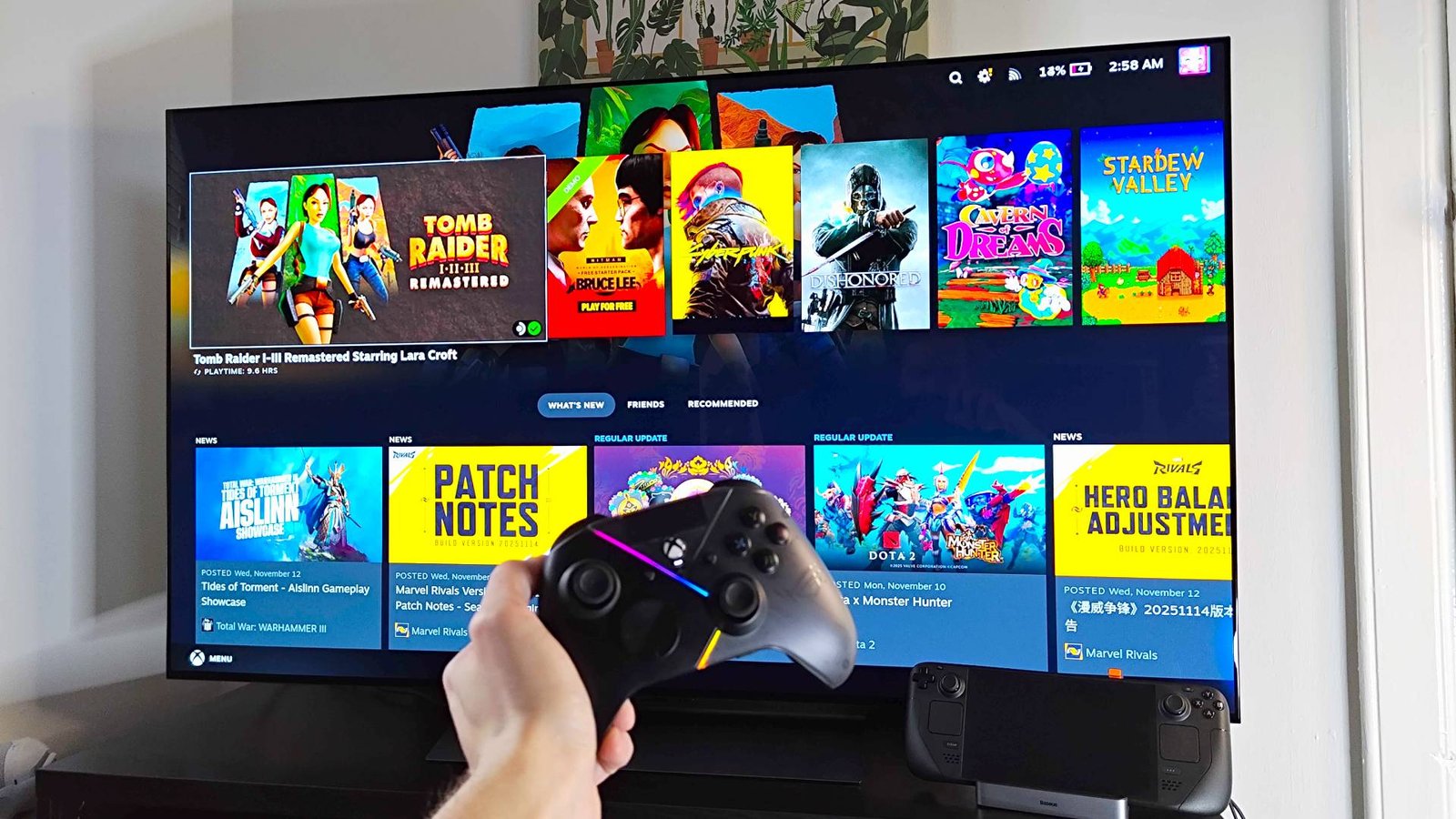 LG OLED C4 connected to Steam Deck with hand holding controller in front.
