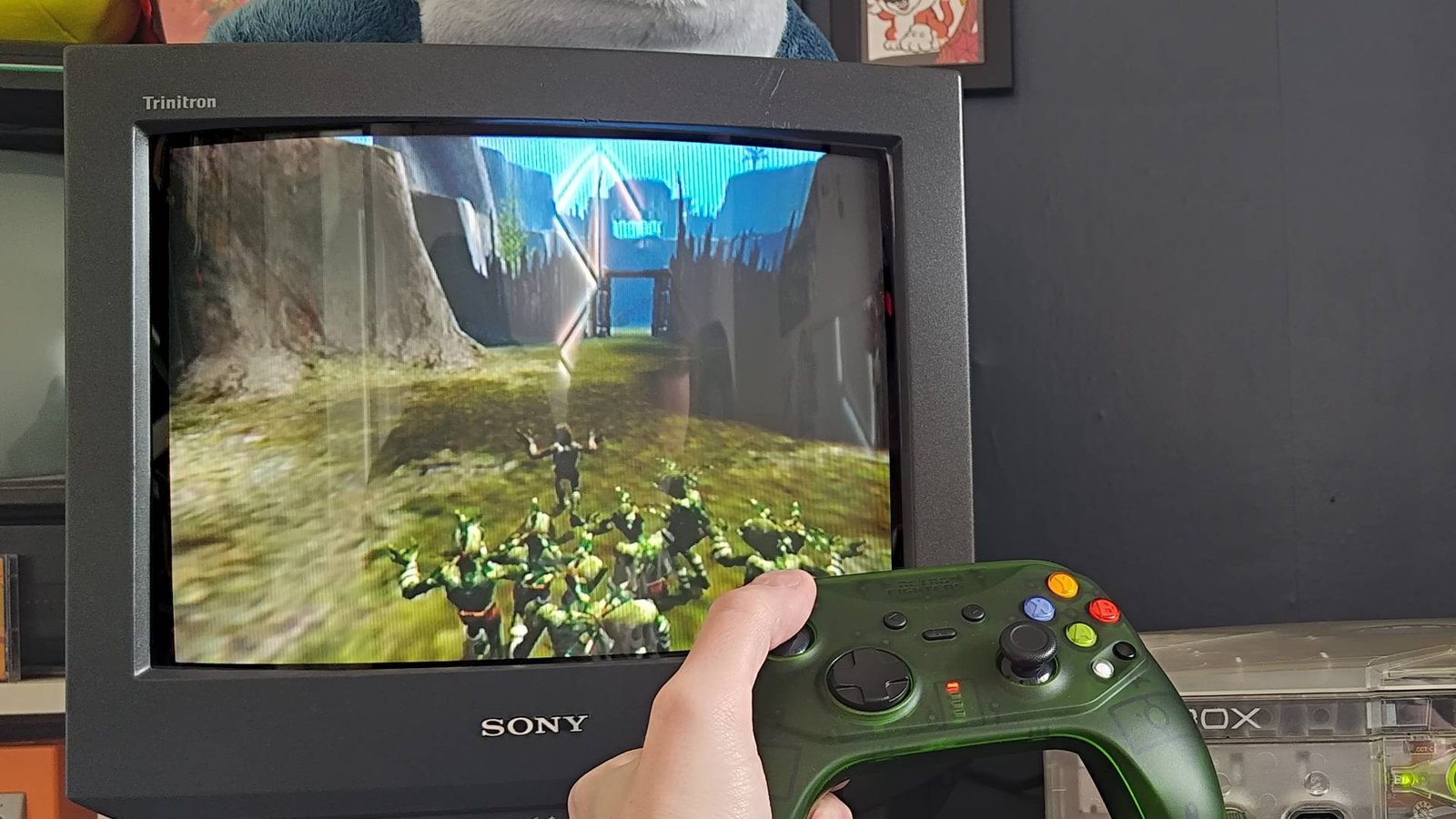 Retro Fighters Hunter controller being used to play Oddworld: Munch's Odyssey on OG Xbox with Abe and pals sneaking.