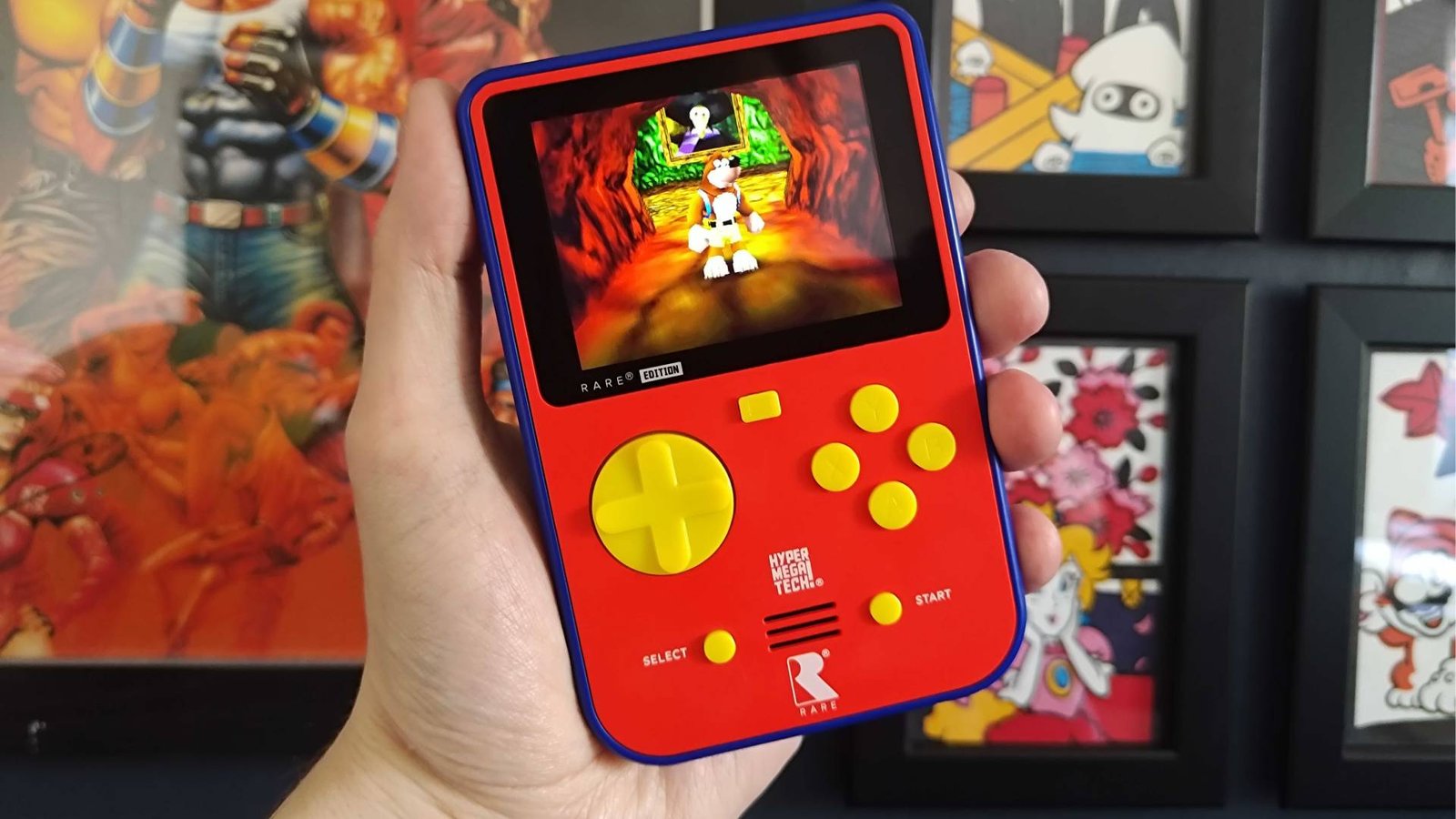 Hand holding Super Pocket with Banjo-Kazooie gameplay on screen.