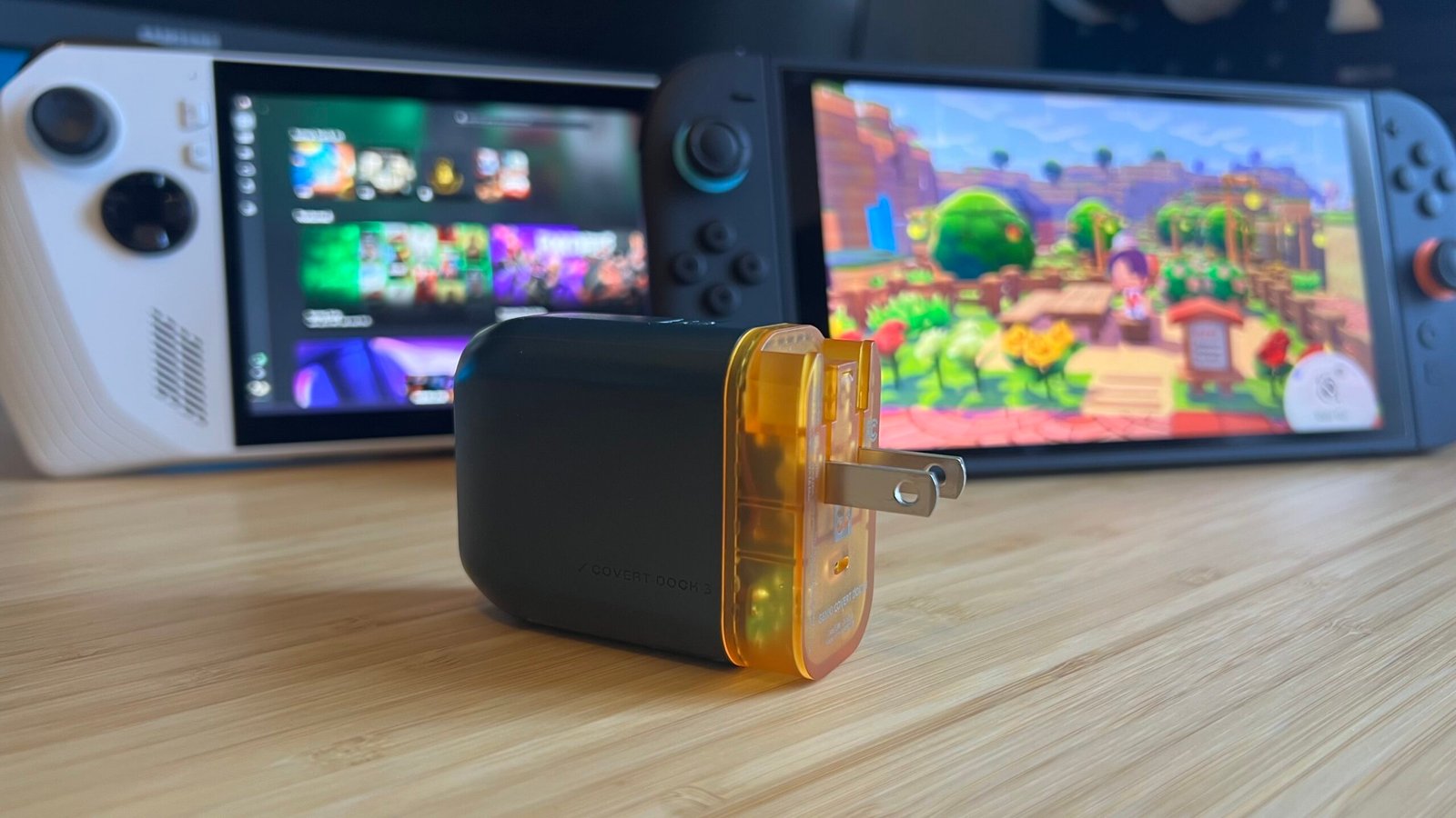Genki Covert Dock 3 on a wooden desk in front of an Asus ROG Ally and Nintendo Switch 2