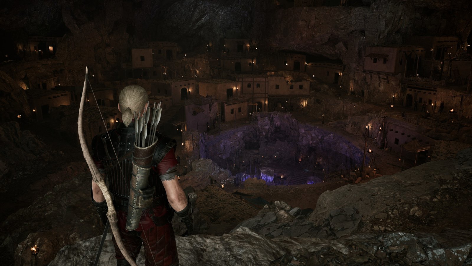 The player looks down across a mining pit in Gothic 1 Remake, dotted by flaming torches