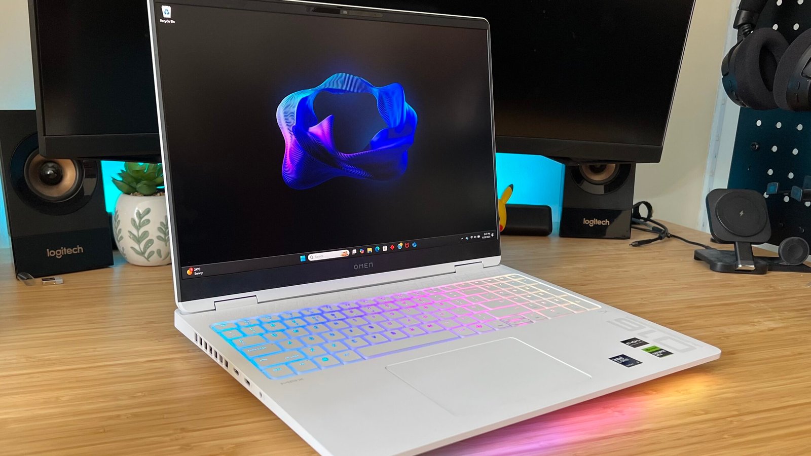 HP Omen Max 16 gaming laptop on a wooden desk with RGB lighting on