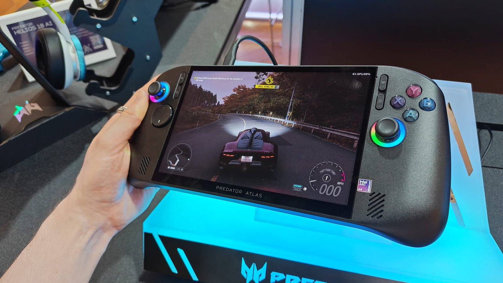 A reviewer holding the Predator Atlas 8 in one hand