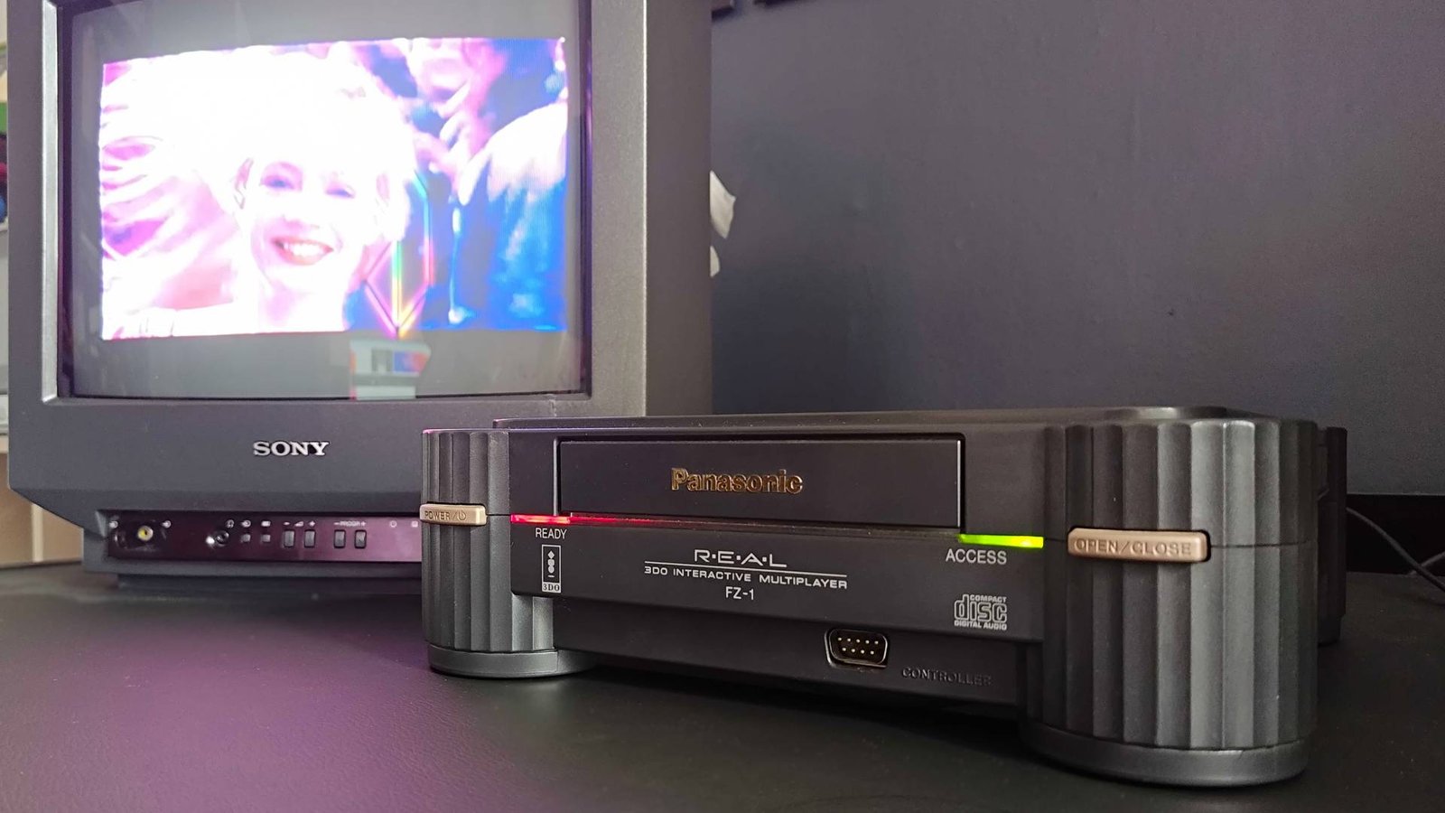 Panasonic 3DO plugged into Sony Trinitron CRT TV with Road Rash cutscene on screen.