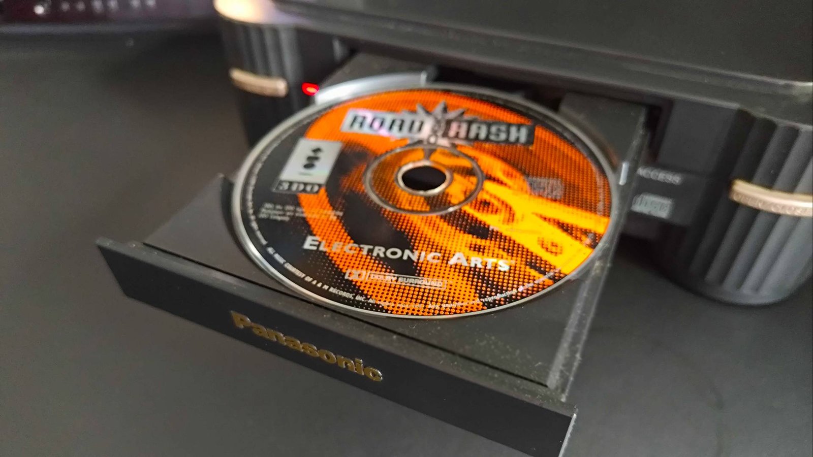 Panasonic 3DO disc drive open with Road Rash disc inserted.