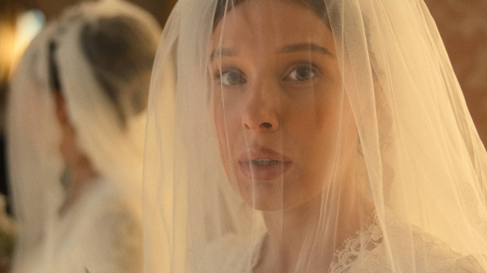 Millie Bobby Brown in Enola Holmes 3 with a wedding veil over her face